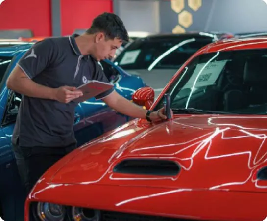 linda cars employee checking a car