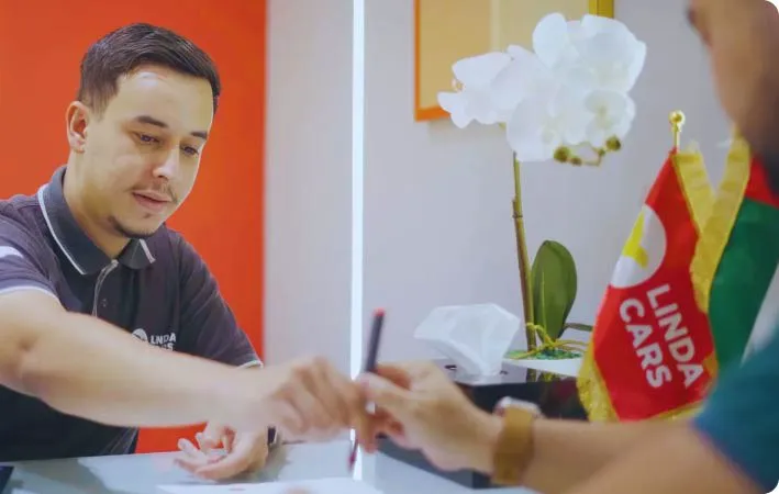 man signing papers